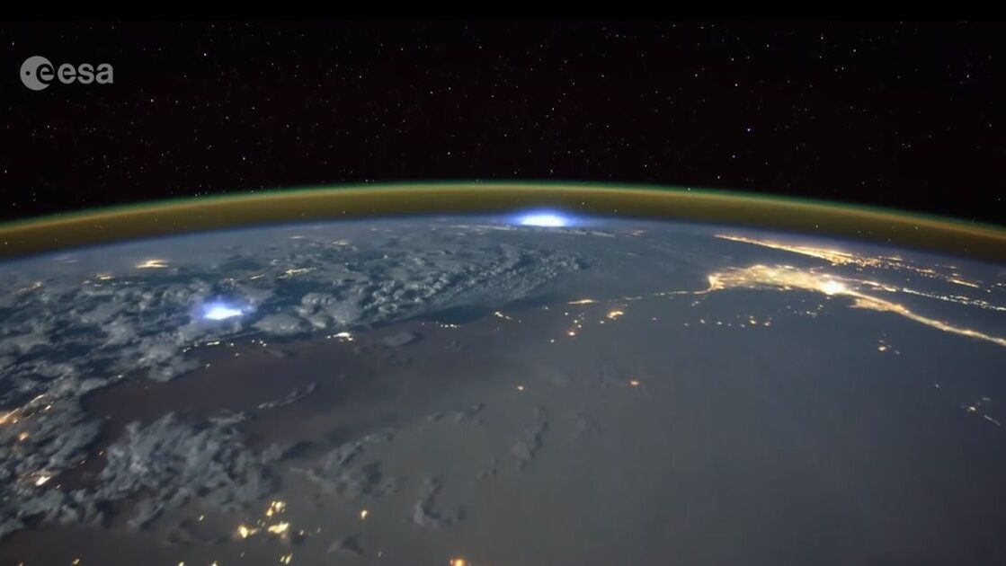 Een foto van de aarde, genomen van de ISS, waarin de atmosfeer en bliksem te zien is